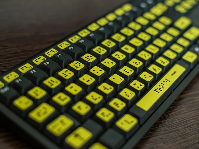 Close up of a keyboard with braille for the blind