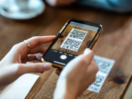 Young woman hands using the smart phone to scan the qr code