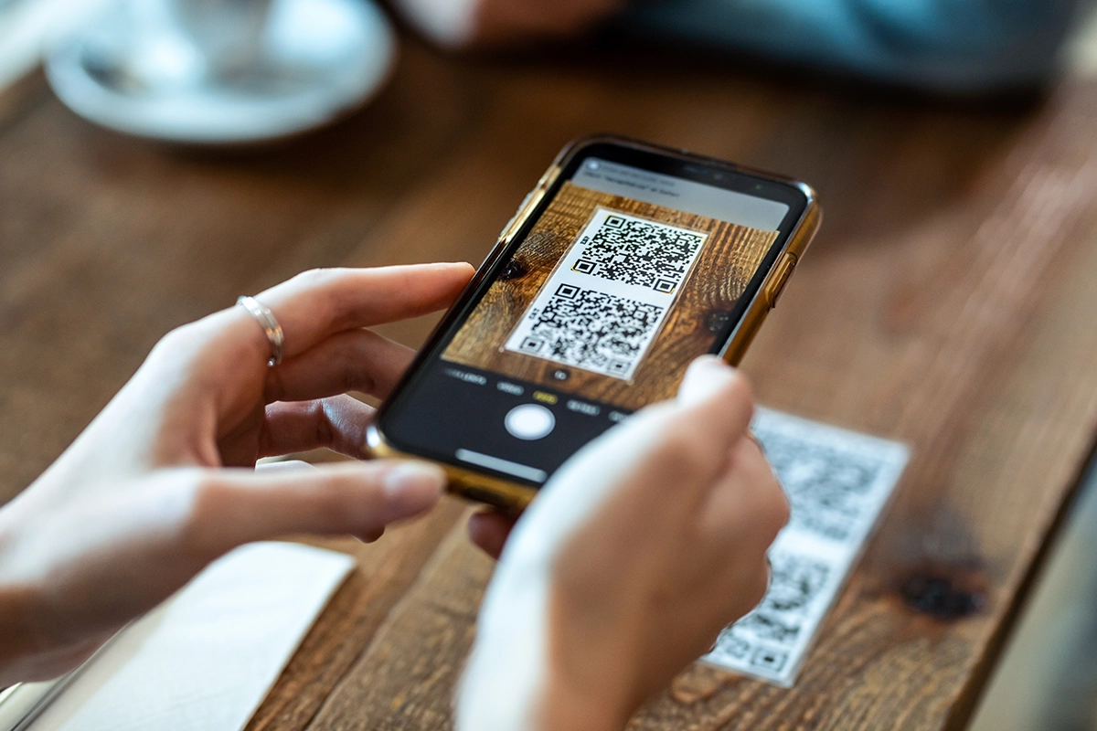 Young woman hands using the smart phone to scan the qr code