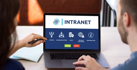 Man and woman access to intranet interface on computer laptop