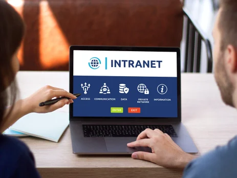 Man and woman access to intranet interface on computer laptop