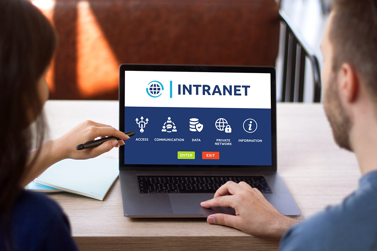 Man and woman access to intranet interface on computer laptop